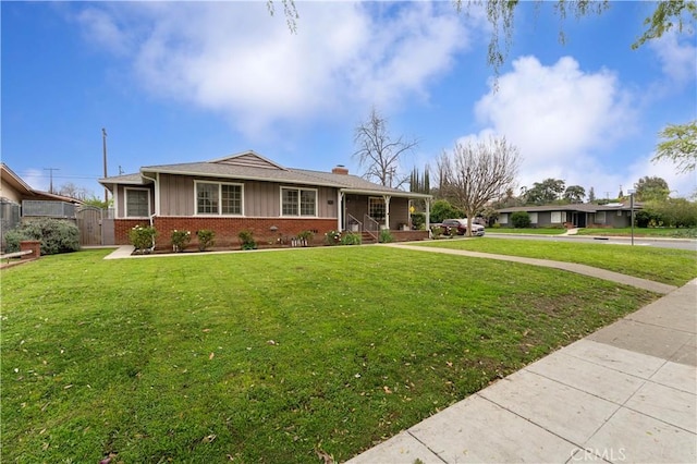 431 Preciado St, Pomona, CA 91768 - view of front of property featuring brick siding, a chimney, a front yard, a gate, and fence