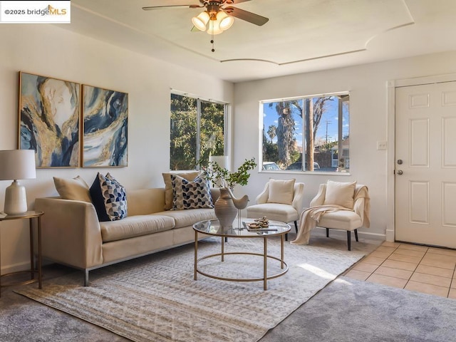 tiled living room with ceiling fan