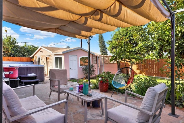 view of patio / terrace featuring a hot tub, a shed, and a pergola