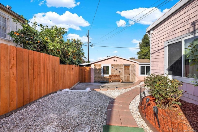 view of yard with a patio and an outdoor structure