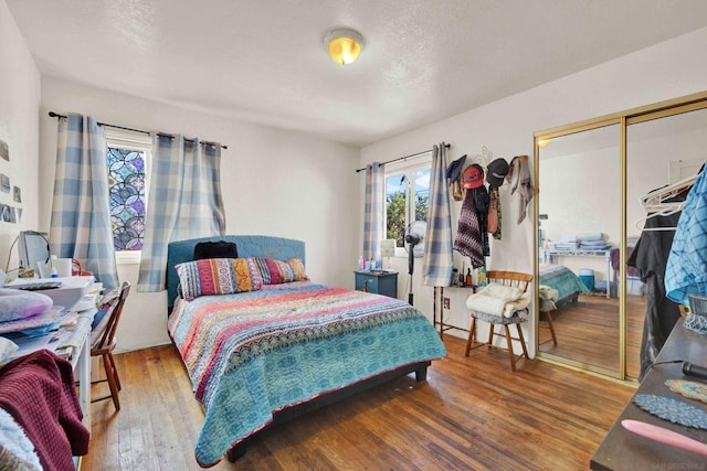 bedroom featuring hardwood / wood-style floors and a closet