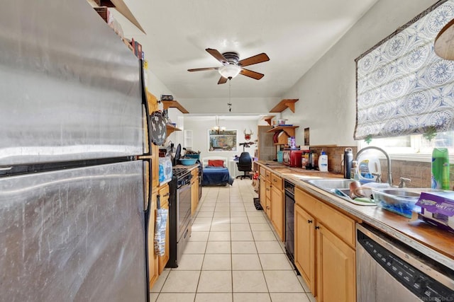 kitchen featuring ceiling fan, light tile patterned floors, sink, and stainless steel appliances