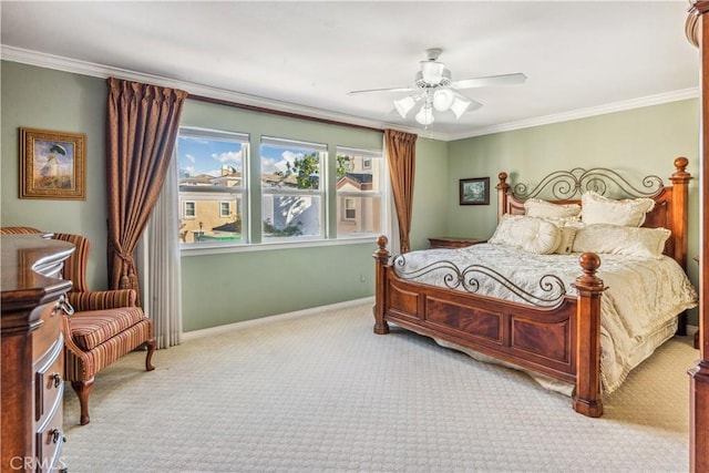 carpeted bedroom with ceiling fan and ornamental molding