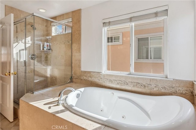 bathroom with shower with separate bathtub