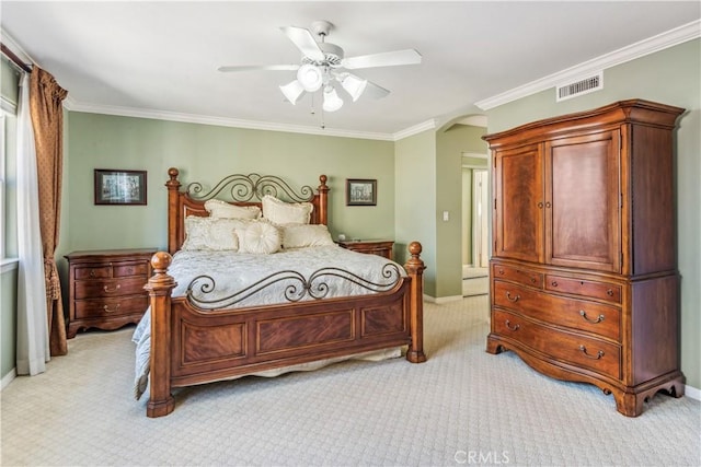 carpeted bedroom featuring ceiling fan and crown molding