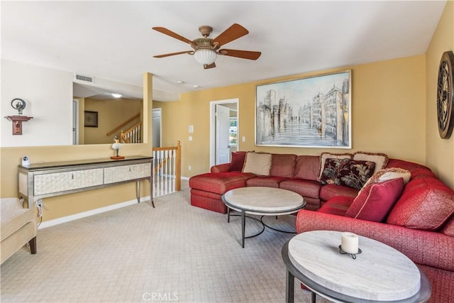 living room with ceiling fan and carpet