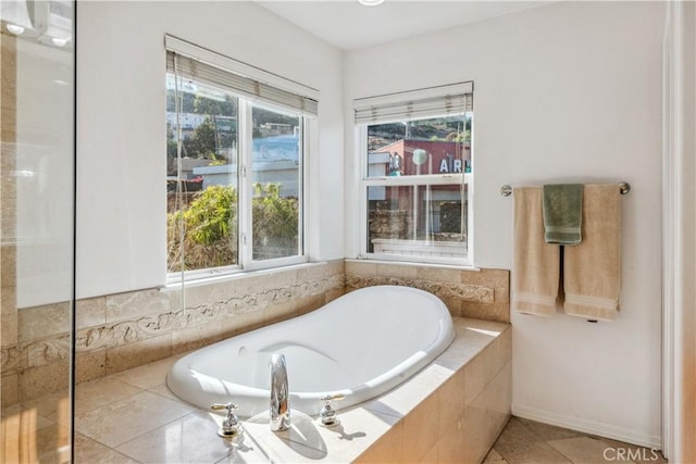 bathroom featuring a relaxing tiled tub and tile patterned floors