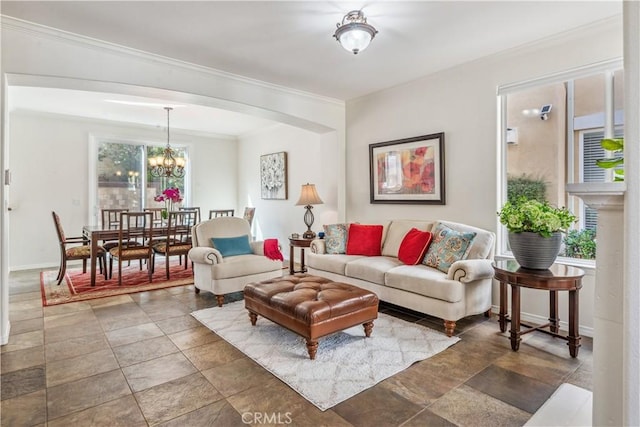 living room with a notable chandelier and crown molding