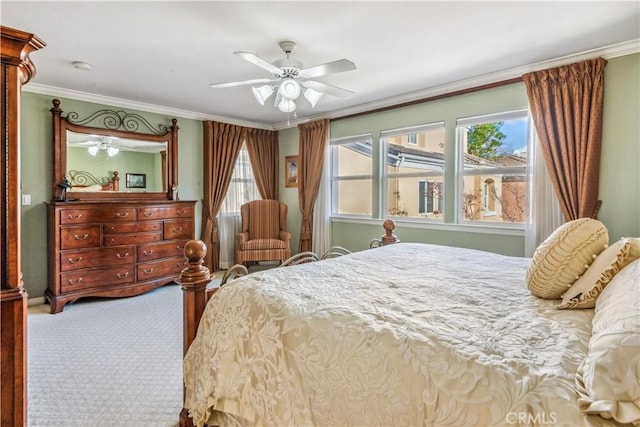 carpeted bedroom with ceiling fan, ornamental molding, and multiple windows