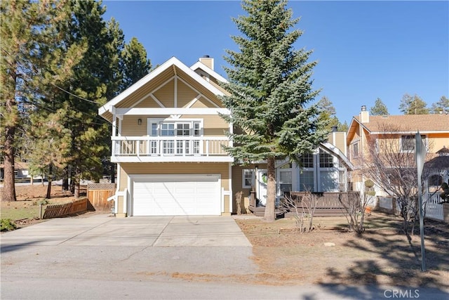 view of front of property featuring a balcony and a garage