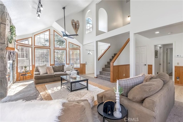 living room featuring ceiling fan and a towering ceiling