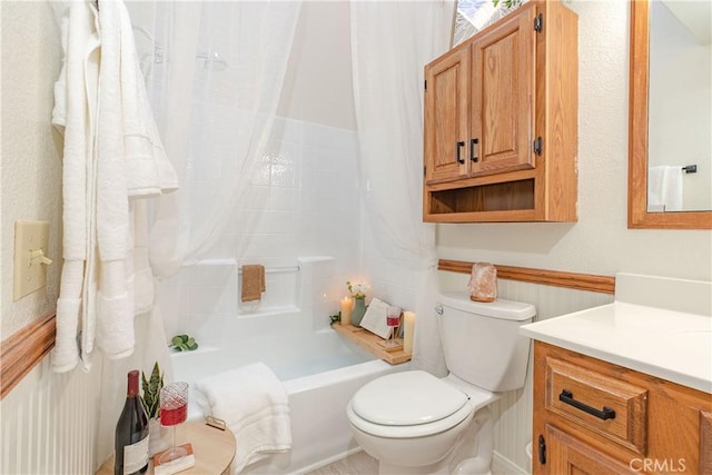 full bathroom featuring toilet, vanity, and shower / tub combo with curtain