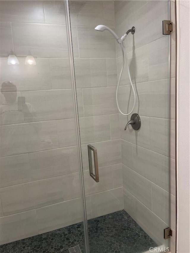 bathroom with a shower with shower door