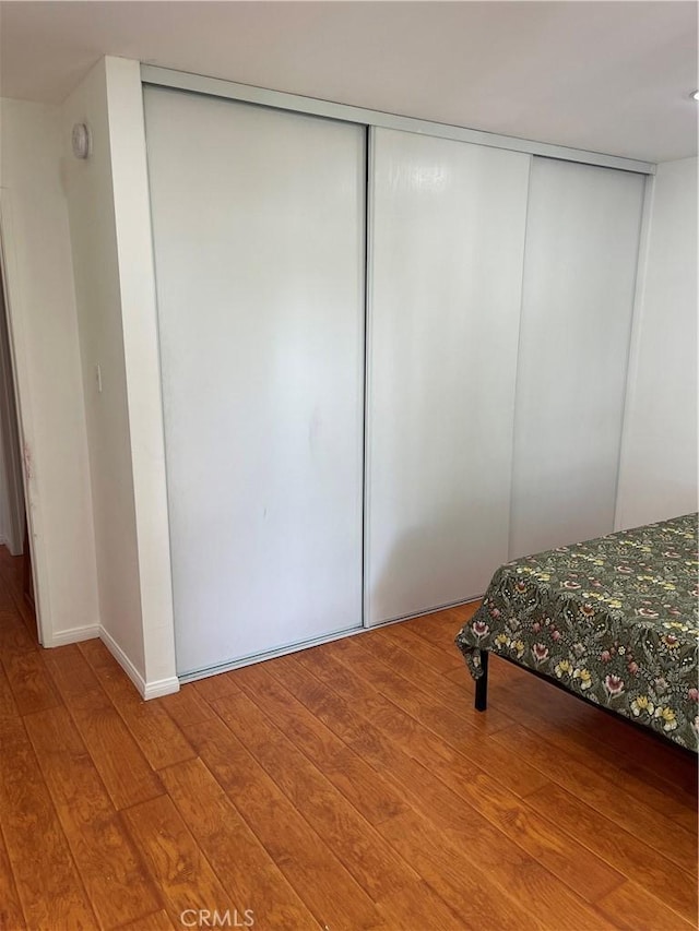 bedroom featuring hardwood / wood-style flooring and a closet