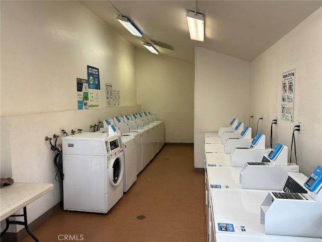 clothes washing area with washer and clothes dryer