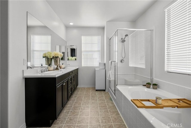 bathroom featuring plus walk in shower, tile patterned flooring, and vanity