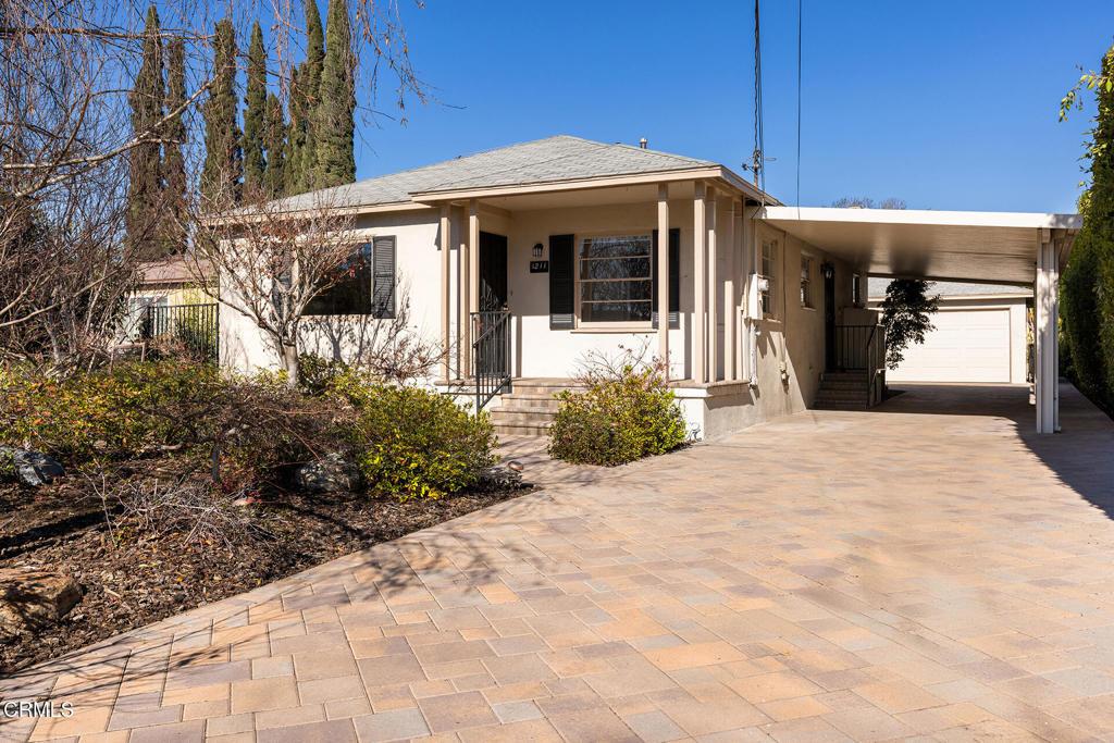 view of front of house featuring a garage and a carport