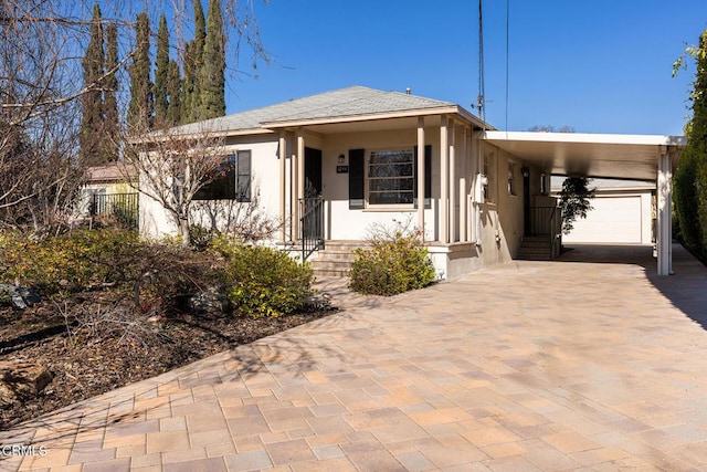 view of front of house featuring a garage and a carport