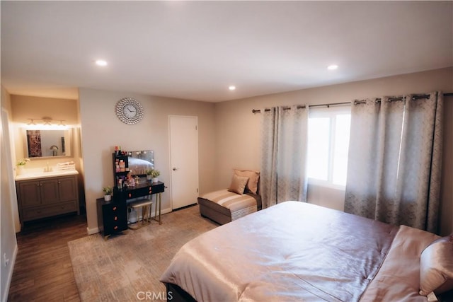 bedroom with wood-type flooring and ensuite bathroom