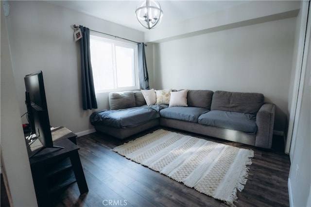 living room featuring a chandelier and dark hardwood / wood-style flooring