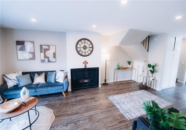 living room with a fireplace and dark hardwood / wood-style floors