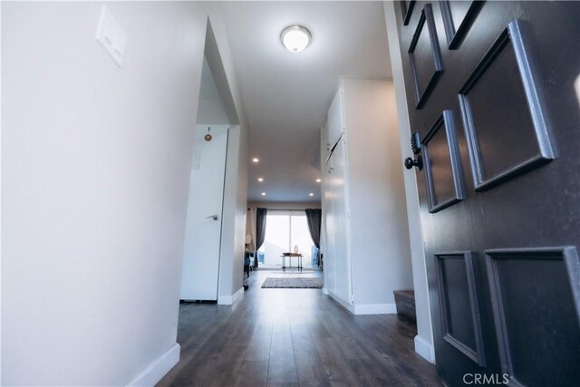 hallway with dark hardwood / wood-style floors