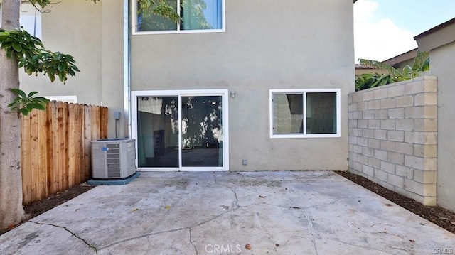 rear view of house featuring cooling unit and a patio area