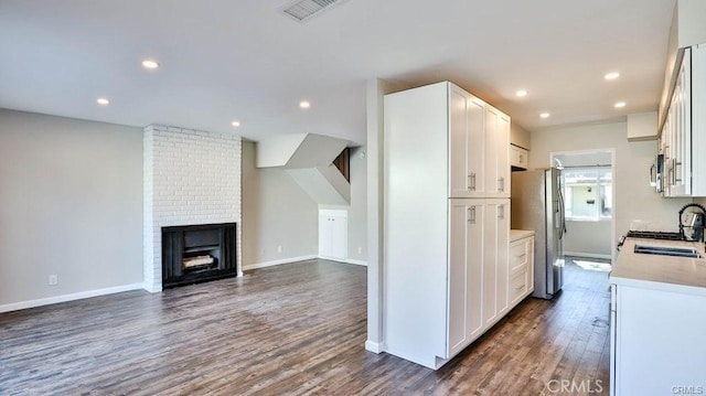 kitchen with white cabinetry, sink, dark wood-type flooring, and appliances with stainless steel finishes