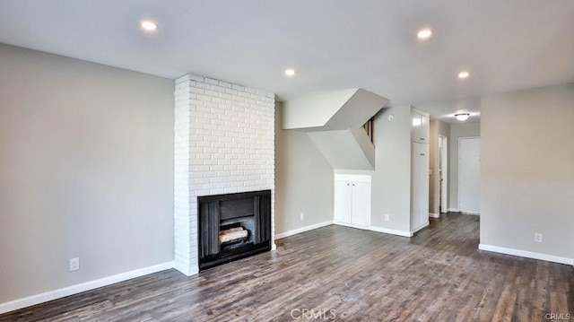 unfurnished living room with dark hardwood / wood-style floors and a fireplace