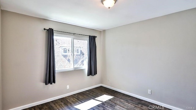 spare room with dark hardwood / wood-style flooring