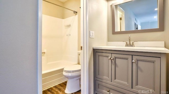 bathroom with vanity, hardwood / wood-style floors, and toilet