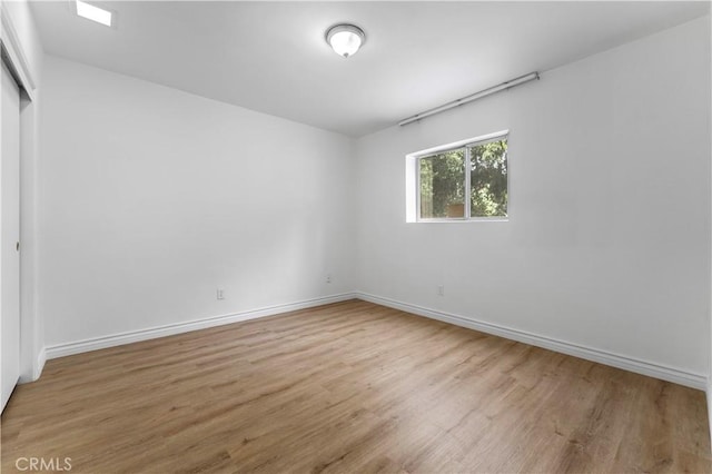 spare room featuring light wood-type flooring