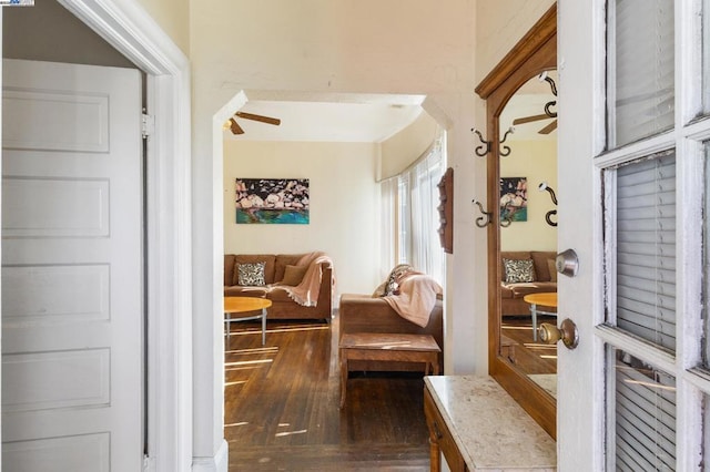 interior space with dark wood-type flooring and ceiling fan