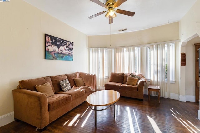 living room featuring ceiling fan and dark hardwood / wood-style floors