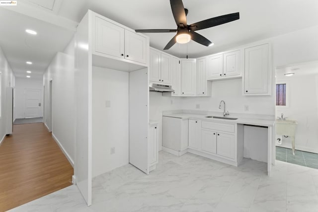 kitchen featuring white cabinetry, ceiling fan, and sink