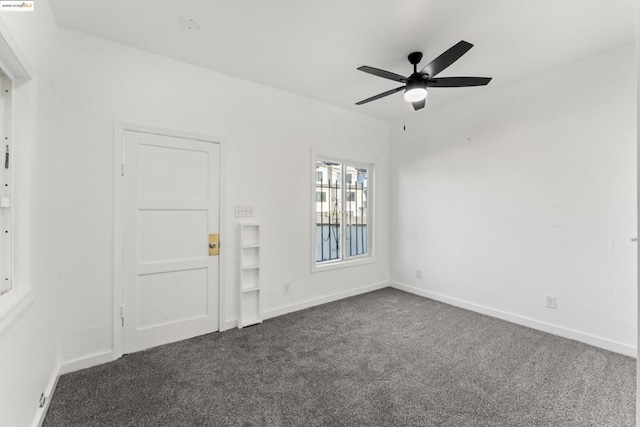 carpeted empty room featuring ceiling fan