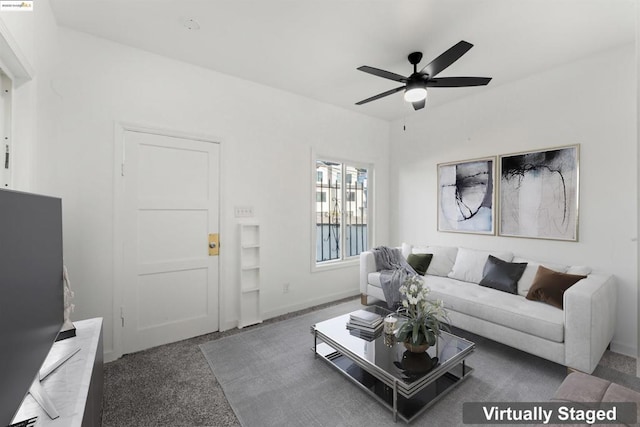 carpeted living room with ceiling fan