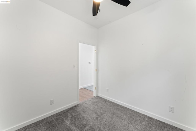 spare room with ceiling fan and carpet