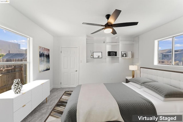 bedroom with ceiling fan and light colored carpet