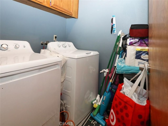 laundry area featuring cabinets and washer and clothes dryer