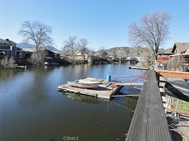 dock area featuring a water and mountain view