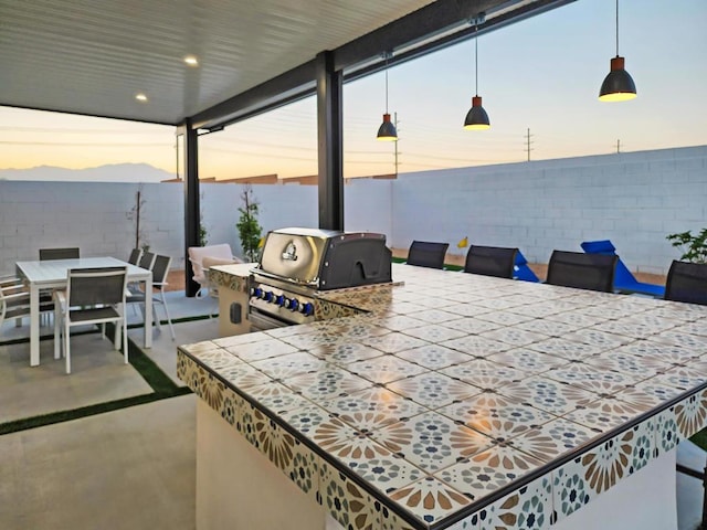 patio terrace at dusk with area for grilling