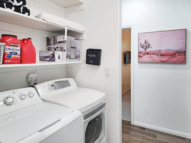 washroom featuring dark hardwood / wood-style floors and washing machine and clothes dryer