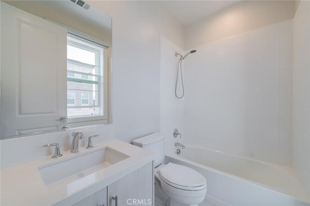 full bathroom featuring washtub / shower combination, vanity, and toilet