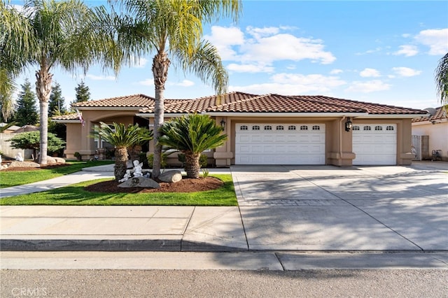 mediterranean / spanish-style home with a garage