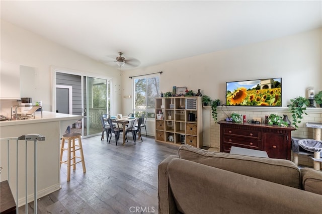 living room featuring ceiling fan, vaulted ceiling, and wood finished floors