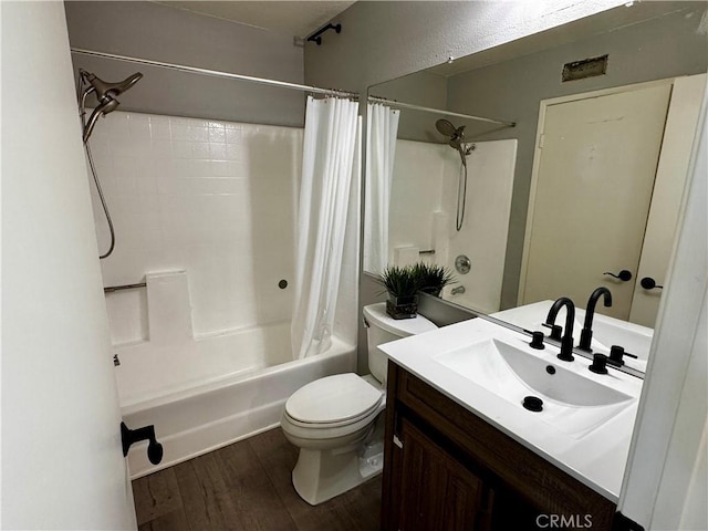 full bathroom featuring toilet, shower / tub combo, wood finished floors, and vanity