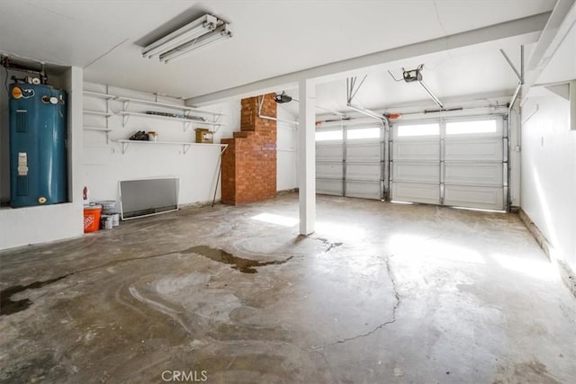 garage featuring water heater and a garage door opener