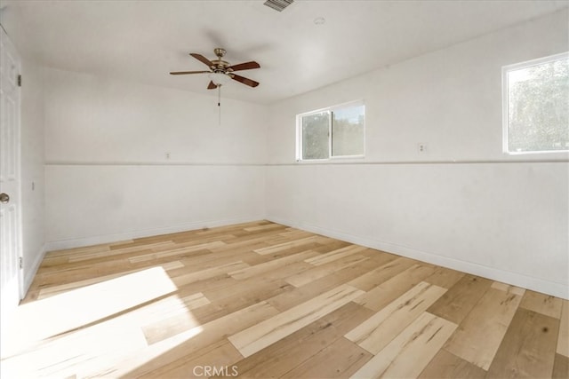 empty room featuring ceiling fan and light hardwood / wood-style floors