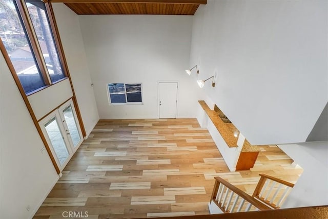 stairway with hardwood / wood-style flooring, french doors, and wood ceiling